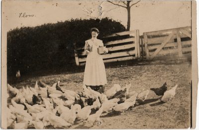 , RPPC likely of Florence Haslam feeding chickens at Stone Cottage, Springfield. (3216), PEI Postcards